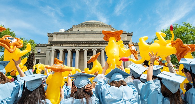Columbia College grads wave inflatable lions in celebration. Photo by Diane Bondareff. Columbia College students wave inflatable lions during Commencement.