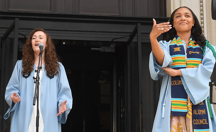 The national anthem was vocally performed by Cayleigh Capaldi (CC'22) and performed in American Sign Language by Morgan Grant (BC'22). Photo by Eileen Barroso. Cayleigh Capaldi and Morgan Grant sing and sign the Nation Anthem