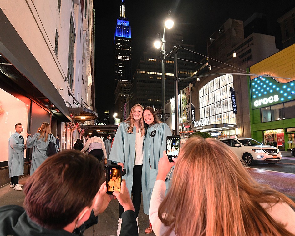 Photo by Eileen Barroso/Columbia University. The Empire State Building image ® is a registered trademark of ESRT Empire State Building, L.L.C. and is used with permission. parents take photos of two friends
