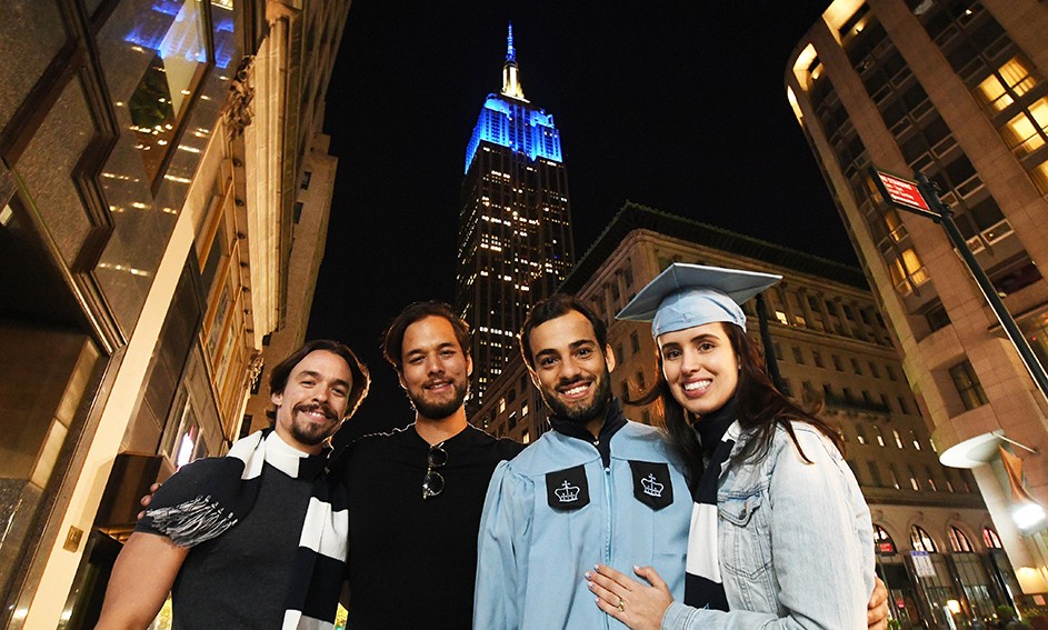Photo by Eileen Barroso/Columbia University. The Empire State Building image ® is a registered trademark of ESRT Empire State Building, L.L.C. and is used with permission. 36th St. and Fifth Avenue with grads and the empire state building