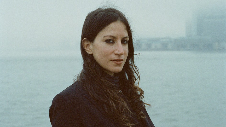 Hannah Assadi received her MFA in writing from the School of the Arts, where she now teaches. Adjunct Writing Professor Hannah Assadi, Columbia University School of the Arts, stands before water