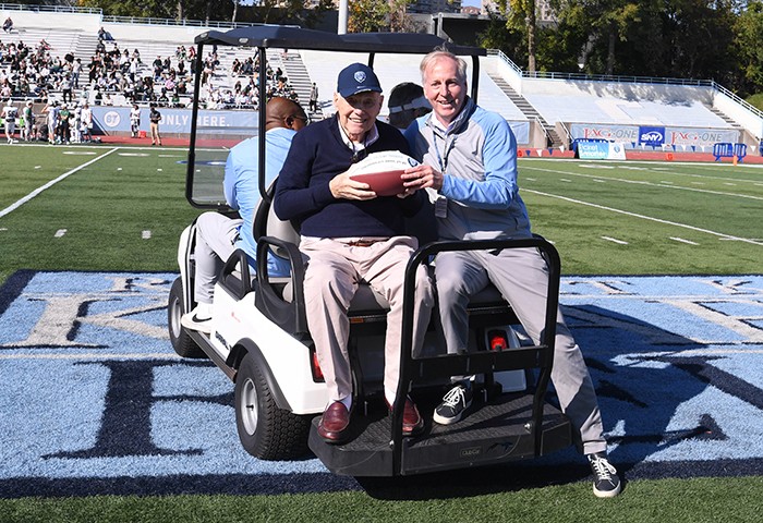 At the game, Columbia celebrated the 75th Anniversary of its upset victory over Army in 1947 in between the first and second quarters. Bill Olson (ENG'49), one of two living members of that squad, was in attendance and received a commemorative football from Pilling. Photo by Eileen Barroso/Columbia College. Columbia celebrated the 75th Anniversary of its upset victory over Army in 1947 in between the first and second quarters. Bill Olson '49SEAS, one of two living members of that squad, was in attendance and received a commemorative football on the field