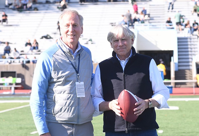 At half time, Peter Pilling, Campbell Family Director of Intercollegiate Athletics and Physical Education, gave Columbia President Lee C. Bollinger a game ball in honor of his last homecoming as intrepid school leadership. Photo by Eileen Barroso/Columbia College. President Bollinger received a game ball at half time.