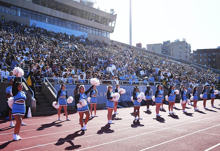 A full stadium at Homecoming with cheerleaders. 