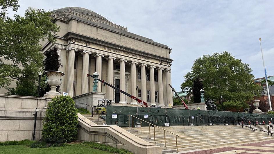 Photo by Columbia University Facilities and Operations. Low Library blocked off by construction on the steps, with cranes.