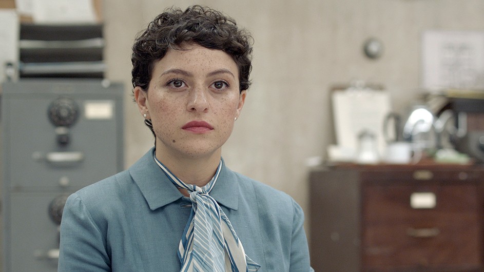 Actress Alia Shawkat as Madeleine Tress in Pride, in a blue shirt.