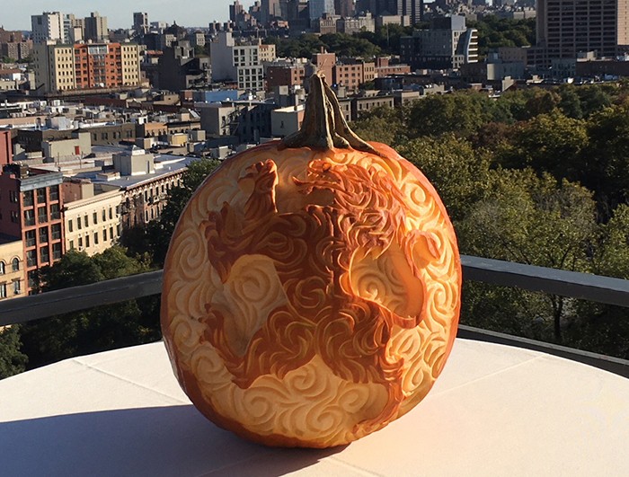 A pumpkin carved like a medieval lion on the balcony of Faculty House