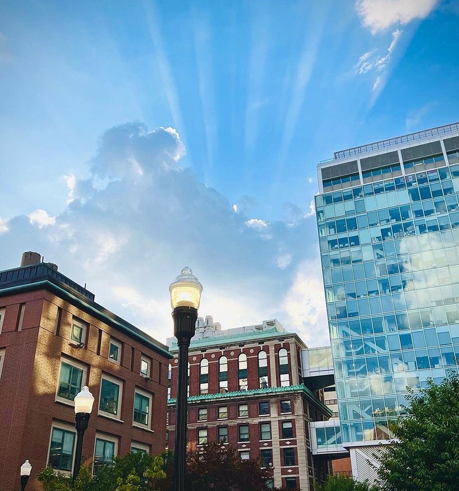 Rays of sunlight illuminate the summer sky behind Columbia's Northwest Corner Building and Havemeyer Hall