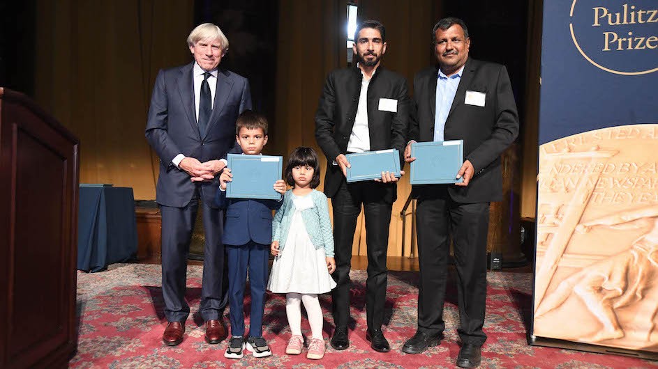 President Lee C. Bollinger with Yunus and Sarah Siddiqui, children of the late Danish Siddiqui, Adnan Abidi, and Amit Dave