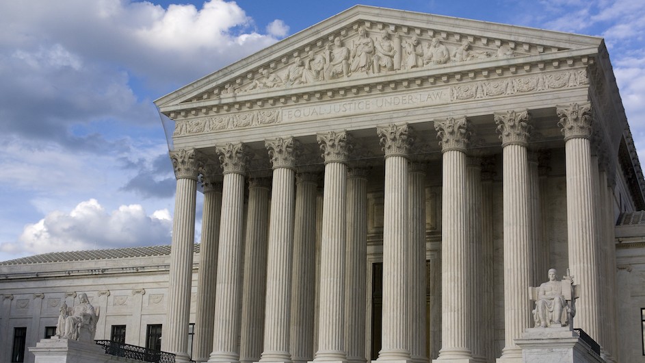 The Supreme Court building, in Washington, D.C., on a partly cloudy day.