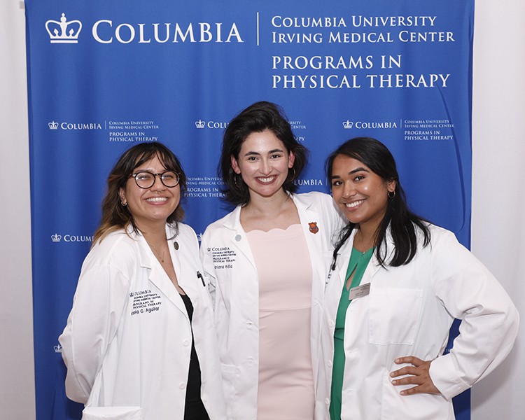 Part of orientation activities include "White Coat" ceremonies, ushering in new classes of nursing, dental, medical, and physical therapy students. Photo by Michael DiVito. Physical Therapy students pose in white coats.