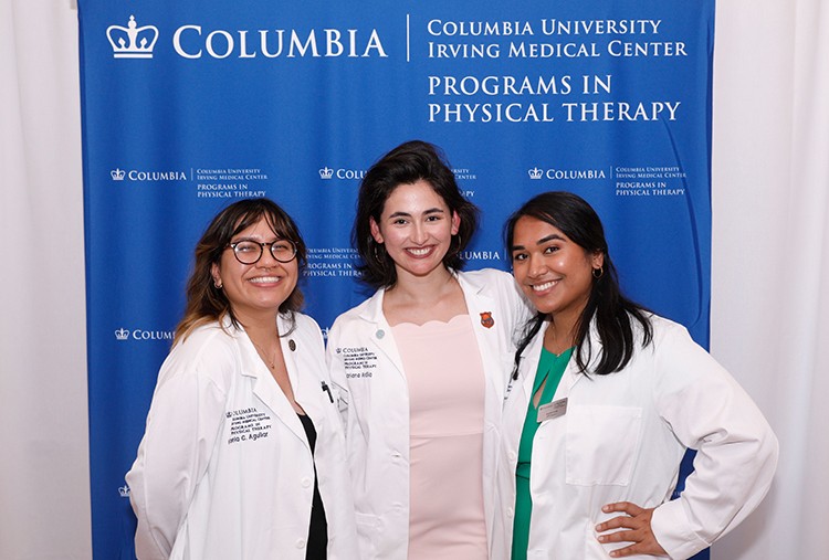 Part of orientation activities include "White Coat" ceremonies, ushering in new classes of nursing, dental, medical, and physical therapy students. Photo by Michael DiVito. Physical Therapy students pose in white coats.