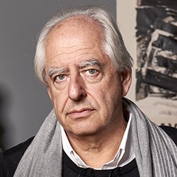 William Kentridge, a man with short, white hair, in a grey scarf, white shirt, and black sweater. 