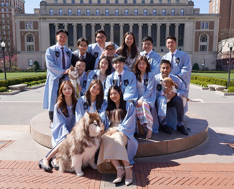 Yibing Chen (SEAS'22) shared this photo with friends and furry loved ones: "In the photo at the sundial, we have three cute dogs in our graduation family!" Courtesy Yibing Chen. A group of friends and their dogs at the sundial