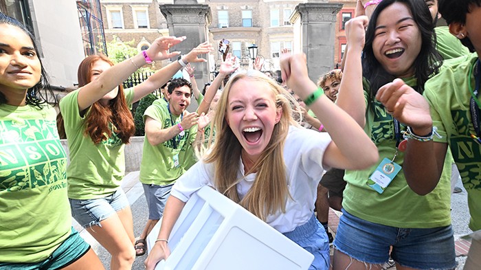 Columbia Housing staff and NSOP leaders cheer new students as they move on to Columbia's Morningside campus. Photo by Eileen Barroso/Columbia College. NSOP leaders cheer as students move in on August 27.