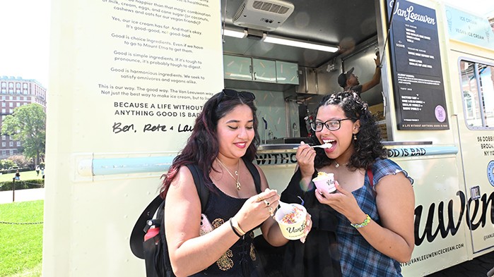 President Shafik offers ice cream to students in line for the ice cream truck.