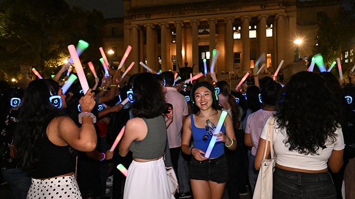 University Life hosted a silent disco on Sept. 7 on Low Plaza, titled "Low-Lapalooza." Photo by Eileen Barroso/University Life. Students dance with headphones on and glow sticks at Low-Lapalooza.
