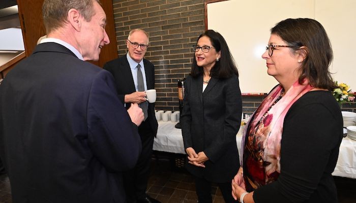 Minouche Shafik standing between Alex Halliday and Maureen Raymo