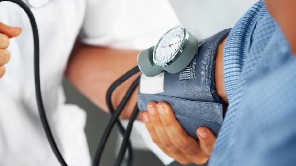 Image of a blood pressure monitor on a person's arm.