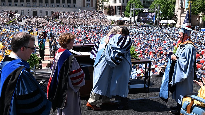 Columbia President Lee C. Bollinger embraces incoming president Minouche Shafik, after conferring an honorary degree, Doctor of Laws, upon her, as is tradition for any incoming president. Photo by Eileen Barroso. President Bollinger and incoming president Minouche Shafik embrace after President Bollinger presented her an honorary degree. Photo by Eileen Barroso.