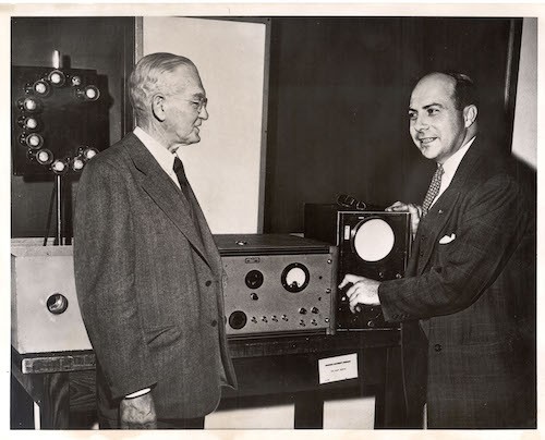 John R. Dunning (right), points out to Dean George Braxton Pegram the workings of his "atomic pinball machine," which he uses to explain atomic energy to the public.