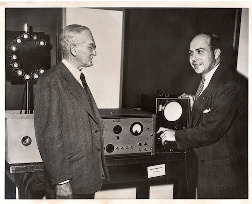 John R. Dunning (right), points out to Dean George Braxton Pegram the workings of his "atomic pinball machine," which he uses to explain atomic energy to the public. (Credit: University Archives, Rare Book & Manuscript Library, Columbia University Libraries.) John R. Dunning (right), points out to Dean George Braxton Pegram the workings of his "atomic pinball machine," which he uses to explain atomic energy to the public.