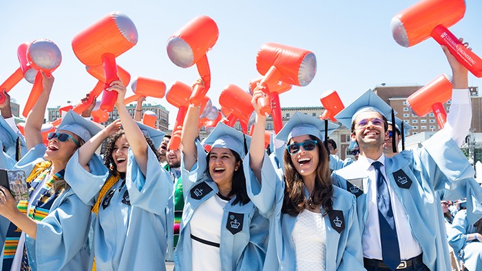 Engineering graduates wave their hammer balloons in excitement after their degrees were conferred. Photo by Diane Bondareff. Engineering students wave hammer balloons. Photo by Diane Bondareff.
