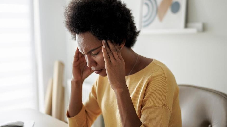 A woman experiencing a headache.