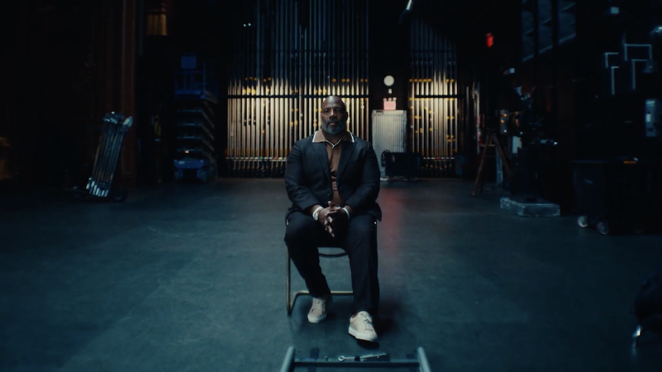 Jelani Cobb, dean of Columbia Journalism School, seated in the center of a sound stage