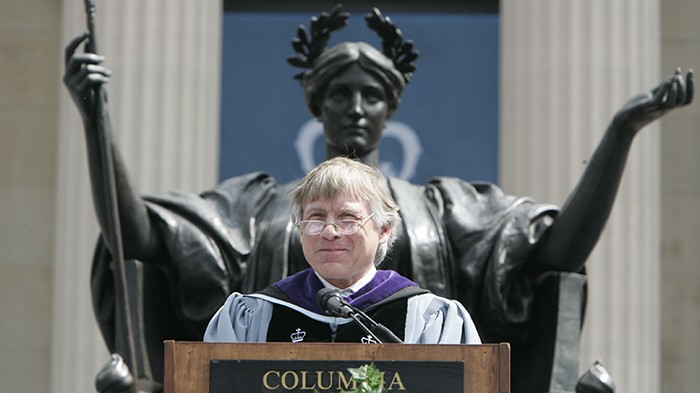 2006 photo by Eileen Barroso. President Bollinger gives a speech in front of the Alma Mater statue at Commencement.