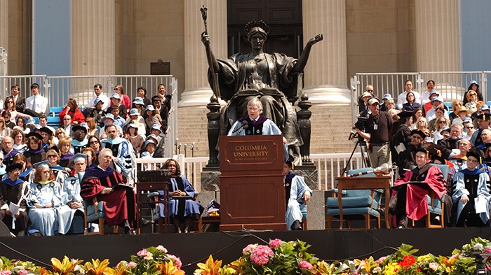 2008 photo by Eileen Barroso. A row of flowers in front of Bollinge giving a speech by Alma Mater.