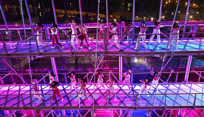 CU Generation dance team at Glass House Rocks in Lerner Hall in 2023. Photo by Eileen Barroso/Columbia Lerner Hall Operations & Event Management. Lerner Hall floors and bridges with lights and a dance team performing.