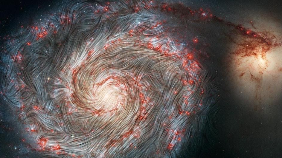 The magnetic field in the Whirlpool Galaxy (M51), captured by NASA's flying Stratospheric Observatory for Infrared Astronomy (SOFIA) observatory superimposed on a Hubble telescope picture of the galaxy. The image shows infrared images of grains of dust in the M51 galaxy. Their magnetic orientation largely follows the spiral shape of the galaxy, but it is also being pulled in the direction of the neighboring galaxy at the right of the frame.
