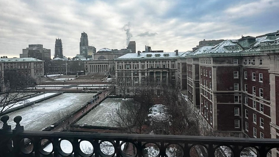 Snow Morningside campus from John Jay Residence Hall showing Low Library, Hamilton Hall, Dodge Hall, College Walk, South Lawn, and other buildings on a partly cloudy winter day.