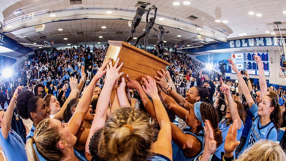 The Columbia Womens Basketball team holds a trophy