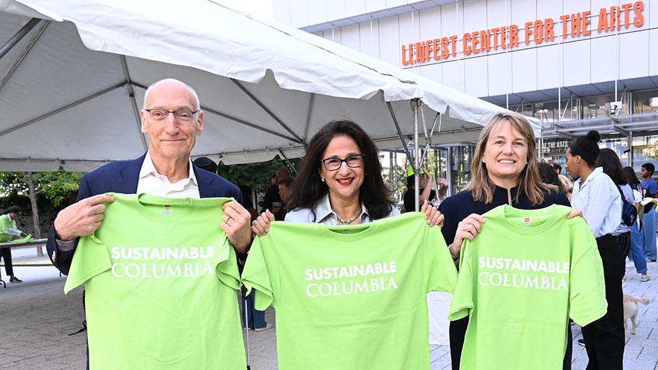Teachers College President Thomas Bailey, Columbia President Minouche Shafik, and Barnard President Laura Rosenbury posing while holding up light green Sustainable Columbia shirts near Lenfest Center for the Arts at Columbia Manhattanville.
