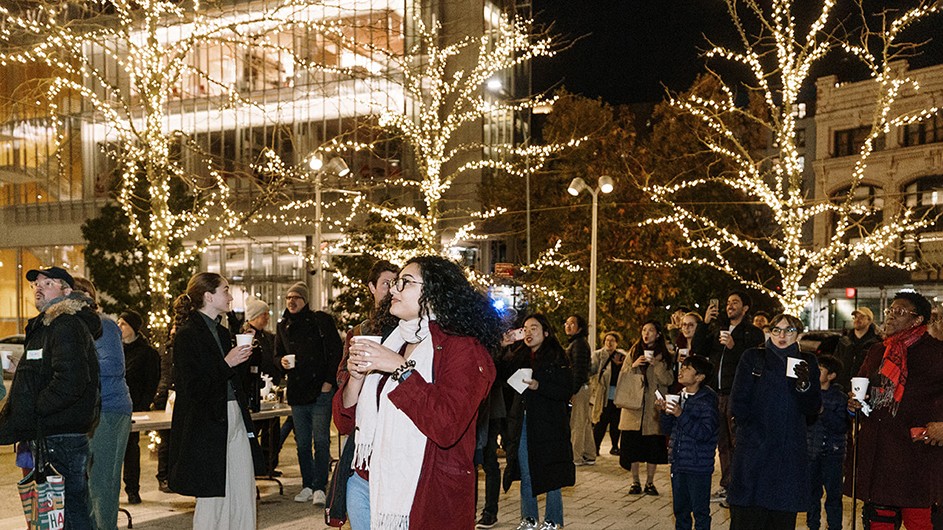 Dozens of spectators enjoy the holiday tree lighting festivities at Columbia Manhattanville. 
