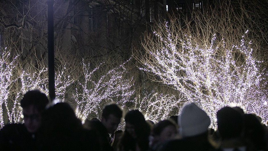 Dozens of students celebrate festivities at the holiday tree-lighting ceremony at Columbia University.