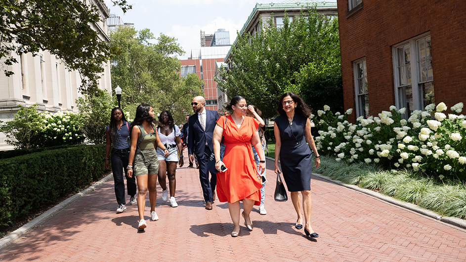 Double Discovery Center (DDC) students, Columbia College Dean Josef Sorett, DDC Executive Director Sasha Wells, and President Minouche Shafik walk through Columbia's campus on the way to a DDC class. Photo by Diane Bondareff/Columbia University.