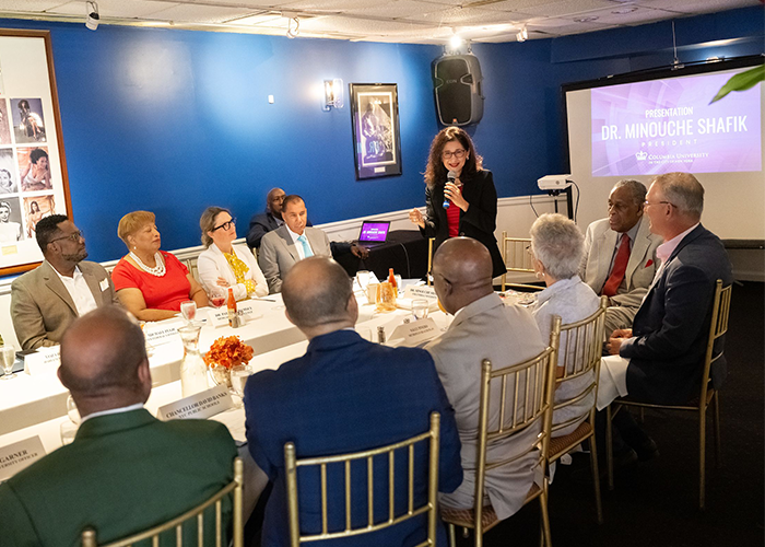 The Greater Harlem Chamber of Commerce recently hosted a welcome breakfast for Columbia University President Minouche Shafik as well as community and education leaders from across the city at the iconic Uptown institution Sylvia's Restaurant. Photo by Diane Bondareff/Columbia University. President Minouche Shafik addresses a group sitting around a table.