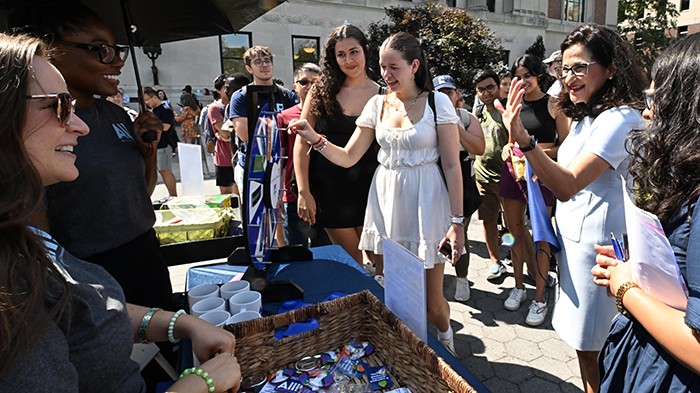 On the first day of classes, Columbia University Life hosted a Resource Fair to welcome students from all campuses and graduating years to learn more about programs and events. President Minouche Shafik stopped by to say hello! Photo by Eileen Barroso. Students and President Minouche Shafik stop by a University Life table at the University Resource Fair