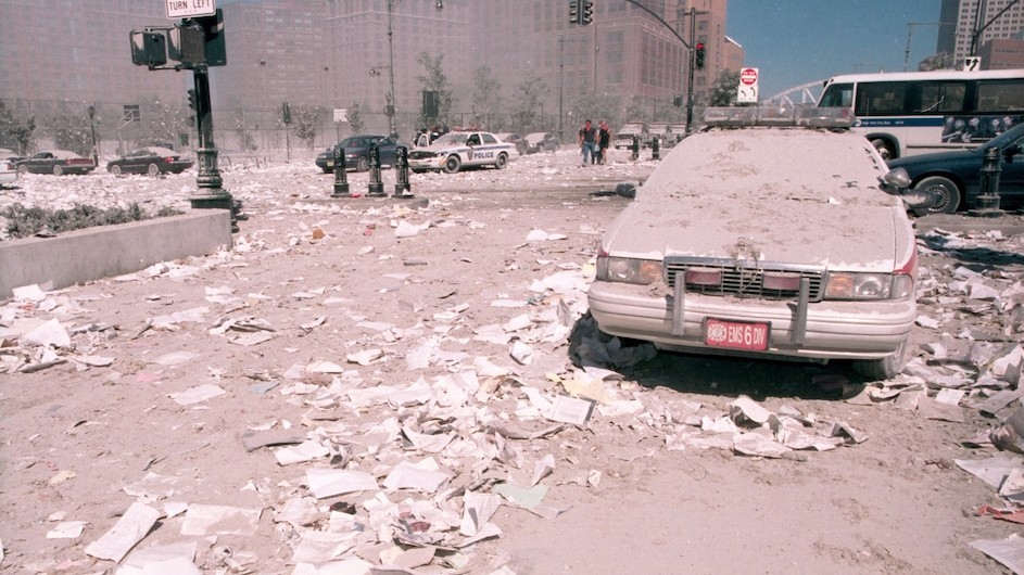 A car covered in ash at the sight of the World Trade Center.