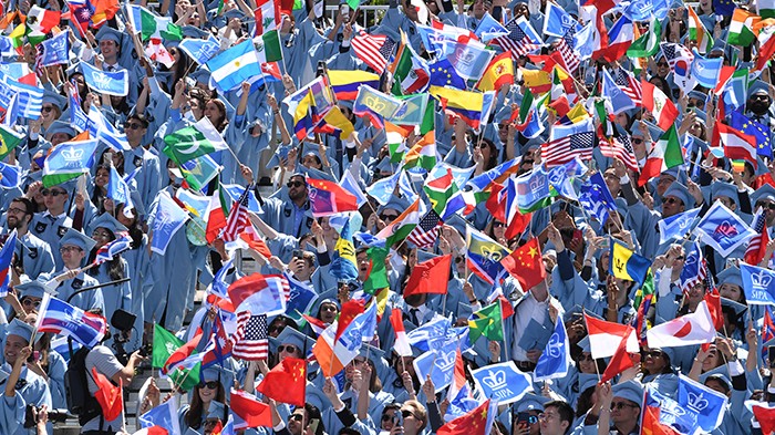 A sea of School of International and Public Affairs graduates. Photo by Eileen Barroso. A sea of Columbia grads waving flags.