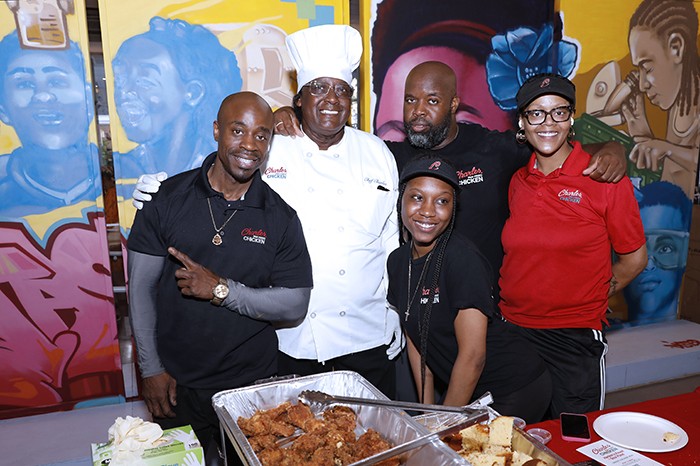A chef and employees at the Taste of Harlem event.