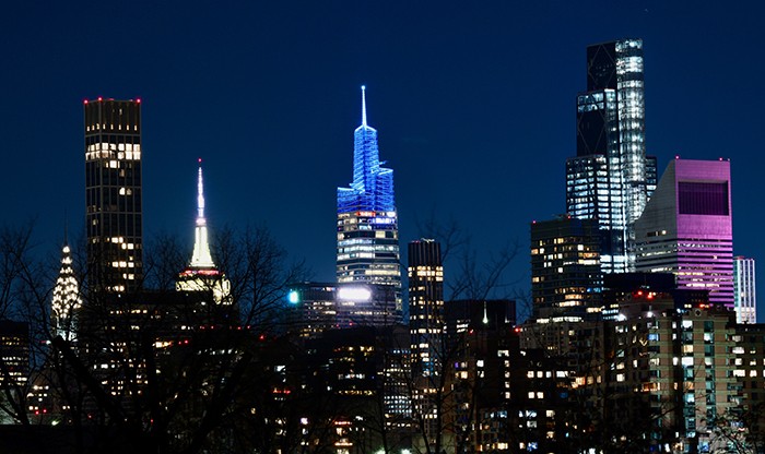 The night of Columbia's big win, Thomas Bow (CC'83, BUS'87) arranged for three buildings to light up Columbia blue on the New York skyline, with the help of Spireworks: One Bryant Park (pictured), 151 West 42nd, and One World Trade Center. Photo by Stockton Photo/Columbia Athletics. One Bryant Park glows blue on Nov. 23.