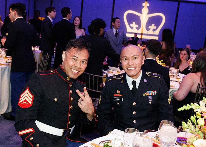 A key to the Columbia veteran experience is the opportunities for coming together as a community, including as mentors, peers, classmates, and good friends. Photo by Sirin Samman. Two uniformed service members at a table at the 2024 Columbia Military Ball. One flashes a peace sign.