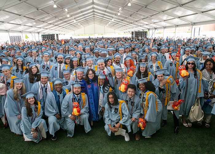 General Studies graduates pose with their owls at the School of General Studies Class Day ceremony on Monday, May 13, at Baker Athletics Complex. Photo by David Dini. A large crowd of graduates at the School of General Studies Graduation