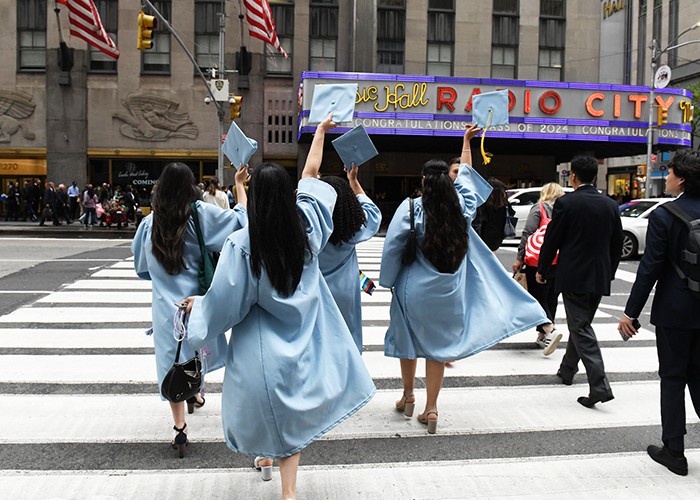 Barnard College grads cross the street to Radio City Music Hall, where their Commencement was held on May 15. Photo courtesy Barnard College. Barnard College grads cross the street to Radio City Music Hall