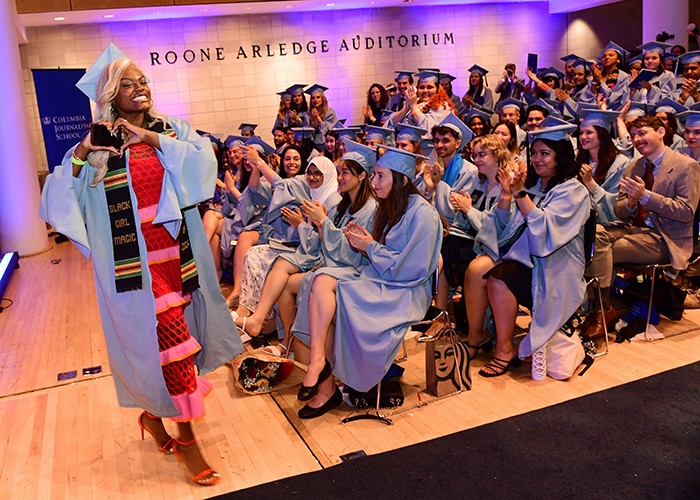 Lotoya Naomi Francis, president of the Columbia Journalism School chapter of Society of Professional Journalists, sends love to the Journalism Class of 2024 after addressing the grads in Lerner Hall's Roone Arledge Auditorium on May 15. Photo by Chris Taggart. A student makes a heart at the graduating class