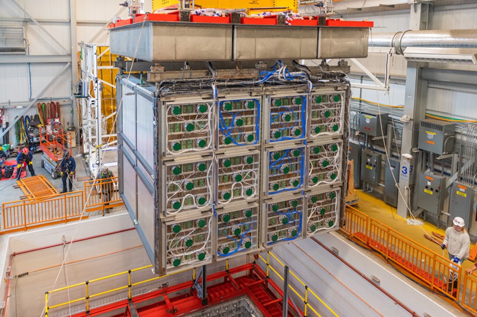 Fermilab technicians and members of the SBND collaboration carefully lower the detector system into the cryostat that will be filled with liquid argon. The move, in April 2023, offered one last glimpse of the wire planes that will enable scientists to record tracks of particles emerging from neutrino collisions. (Ryan Postel/Fermilab) Fermilab technicians and members of the SBND collaboration carefully lower the detector system into the cryostat that will be filled with liquid argon. The move, in April 2023, offered one last glimpse of the wire planes that will enable scientists to record tracks of particles emerging from neutrino collisions.
